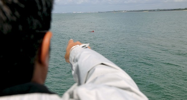 Lookout pointing towards man in water